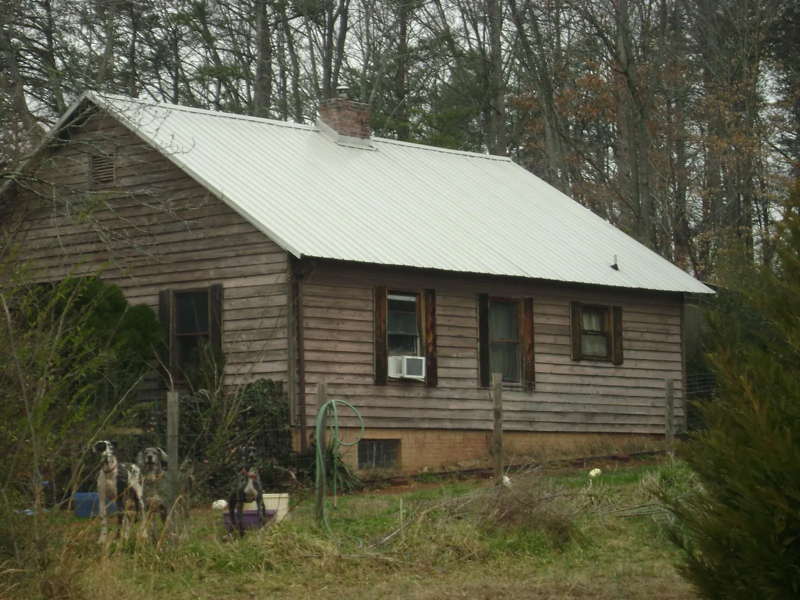 White metal roof on an old wood sided farmhouse, from a Metal Roof Installation job in South Holland